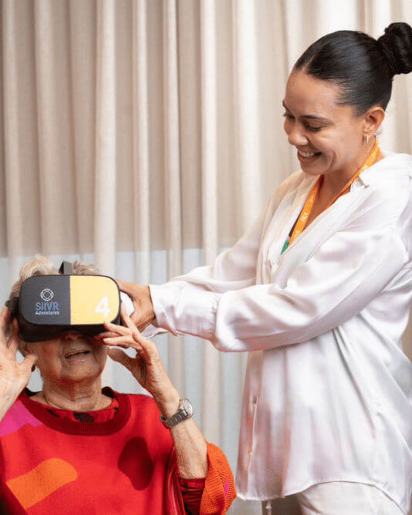 Lifestyle coordinator supporting resident with VR